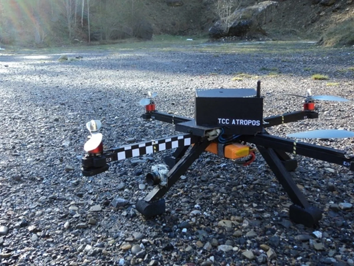 The Atropos quadcopter sitting on a gravel riverbed